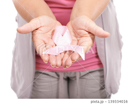 Studio person, breast cancer ribbon and hands show bow awareness icon, kindness or activism support. Health wellness care, recognition campaign or closeup model giving compassion on white background Studio person, breast cancer ribbon and hands show bow awareness icon, kindness or activism support. Health wellness care, recognition campaign or closeup model giving compassion on white background 139334016