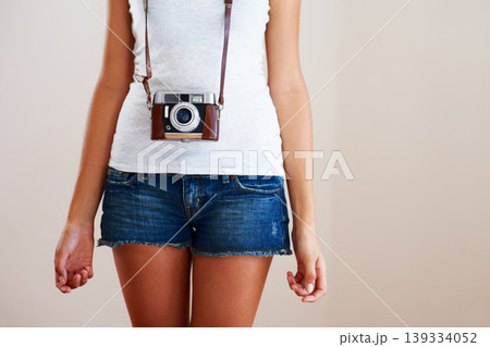 Camera, woman and closeup of a photographer in studio for travel, photography or creativity. Trendy casual fashion of a female model person, student or tourist on a white background in shorts Camera, woman and closeup of a photographer in studio for travel, photography or creativity. Trendy casual fashion of a female model person, student or tourist on a white background in shorts 139334052