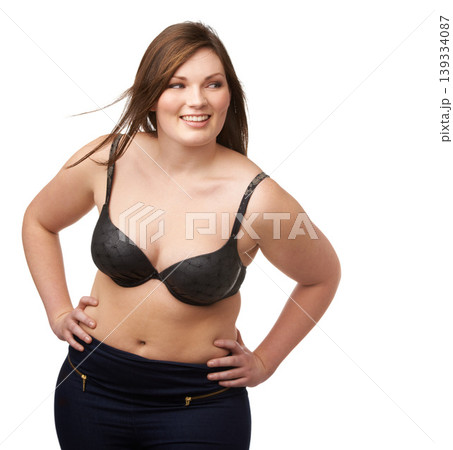 Thinking, smile and bra with a plus size woman in studio isolated on a white background for body positivity. Idea, vision and a happy young model looking natural or confident in her underwear 139334087