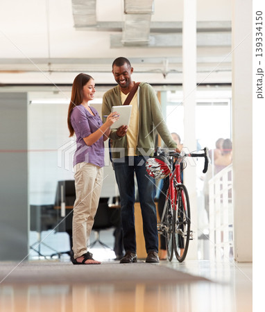 People, talking and tablet in office with bicycle for travel or morning commute to workplace. Bike messenger, logistics and discussion of business, project or checklist with employees and client People, talking and tablet in office with bicycle for travel or morning commute to workplace. Bike messenger, logistics and discussion of business, project or checklist with employees and client 139334150