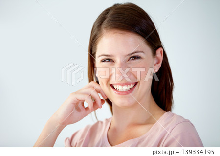 Portrait, happy and face of woman in studio to relax for break, rest or confident personality on white background. Beautiful young model smile for good mood, pride and positive for optimism in Sweden Portrait, happy and face of woman in studio to relax for break, rest or confident personality on white background. Beautiful young model smile for good mood, pride and positive for optimism in Sweden 139334195