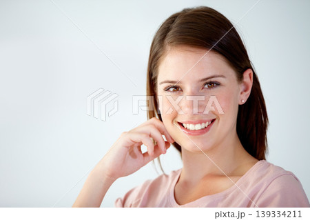 Portrait, face of woman and smile in studio to relax for break, rest and confident personality on white background. Happy, young and beautiful model with good mood, pride and optimism at mockup space Portrait, face of woman and smile in studio to relax for break, rest and confident personality on white background. Happy, young and beautiful model with good mood, pride and optimism at mockup space 139334211