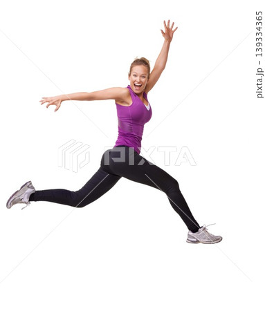 Woman, winner and jump for fitness success, workout and training celebration, energy or achievement in studio. Portrait of sports model or runner in air for exercise and cardio on a white background 139334365