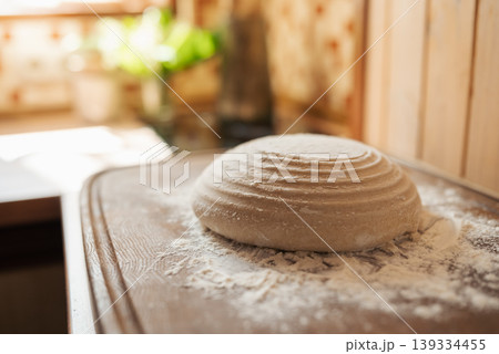 Close up of bread dough on table before baking it in the oven. Cooking at home, baking handmade bread at home Close up of bread dough on table before baking it in the oven. Cooking at home, baking handmade bread at home 139334455
