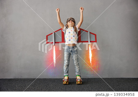 Happy child pretend to be astronaut. Funny kid with paper rocket. Little boy playing indoors 139334958