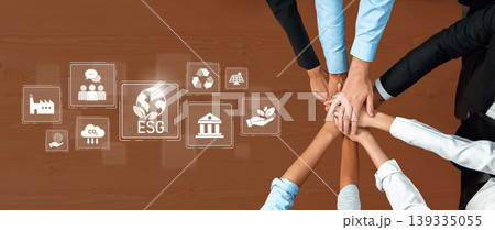 Collaborative Hands on Table Showcasing ESG Concepts with Sustainability Icons Representing Environment, Social Responsibility, and Governance Principles Trope Collaborative Hands on Table Showcasing ESG Concepts with Sustainability Icons Representing Environment, Social Responsibility, and Governance Principles Trope 139335055