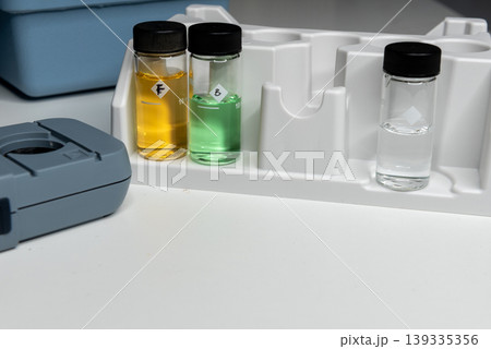 Portable water testing kit with sample vials and container 139335356