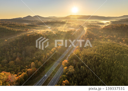 American highway in North Carolina Appalachian mountains in fall season with fast moving traffic. Interstate transportation concept American highway in North Carolina Appalachian mountains in fall season with fast moving traffic. Interstate transportation concept 139337531