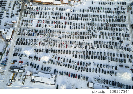 Aerial view of vehicle open market lot with many cars for sale parked and people customers walking in winter Aerial view of vehicle open market lot with many cars for sale parked and people customers walking in winter 139337544