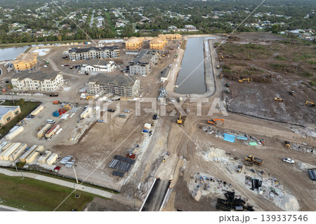 Aerial view of unfinished wooden frames of apartment buildings under construction. Development of residential housing in American suburbs. Real estate market in the USA 139337546