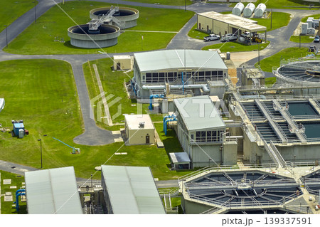 Aerial view of modern water cleaning facility at urban wastewater treatment plant. Purification process of removing undesirable chemicals, suspended solids and gases from contaminated liquid Aerial view of modern water cleaning facility at urban wastewater treatment plant. Purification process of removing undesirable chemicals, suspended solids and gases from contaminated liquid 139337591