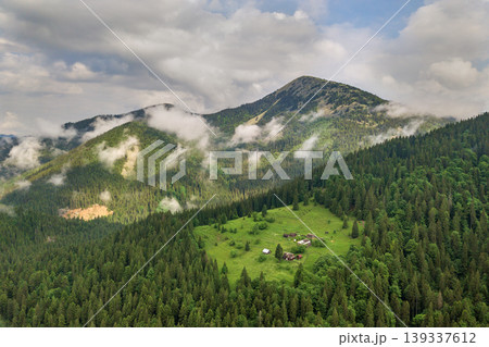 Aerial view of green Carpathian mountains covered with evergreen spruce pine foreston summer sunny day. Aerial view of green Carpathian mountains covered with evergreen spruce pine foreston summer sunny day. 139337612