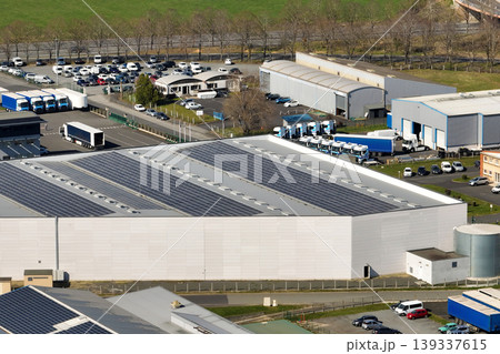 Aerial view of goods warehouses and logistics center in industrial city zone from above Aerial view of goods warehouses and logistics center in industrial city zone from above 139337615