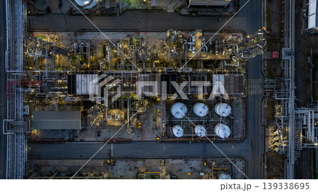 Aerial view Oil and Gas refinery industrial at night, Oil and Gas refinery plant form industry, Refinery plant factory white oil storage tank at night, Oil and Gas refinery plant from industry zone. 139338695