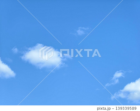 Bright Blue Sky with Scattered White Fluffy Clouds Bright Blue Sky with Scattered White Fluffy Clouds 139339589