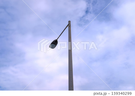 Close-up of the streetlight with blue sky background. City light in the street. Cityscape and downtown scene. Close-up of the streetlight with blue sky background. City light in the street. Cityscape and downtown scene. 139340299
