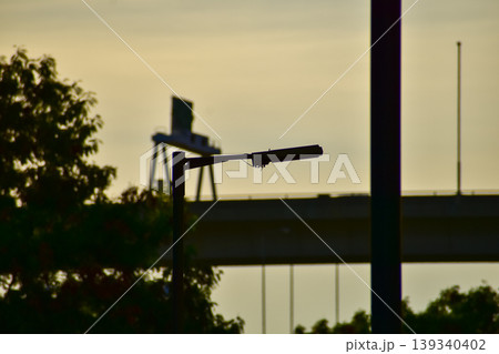 Close-up of the streetlight at the sunset, City light in the street with sky background. Cityscape and downtown scene. Close-up of the streetlight at the sunset, City light in the street with sky background. Cityscape and downtown scene. 139340402