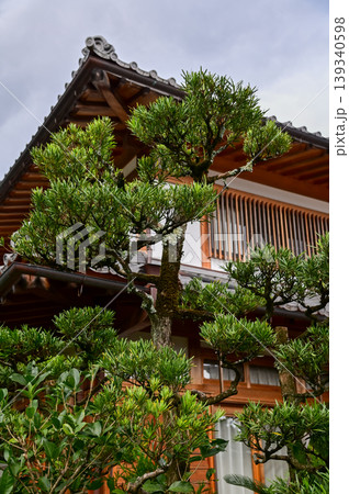 Close-up of the roof of Tenryuji Temple in Kyoto, Japan with trees. Roof tile pattern. Major tourist attraction in Kansai region in Japan. Japan famous historic architecture. Building structure. 139340598
