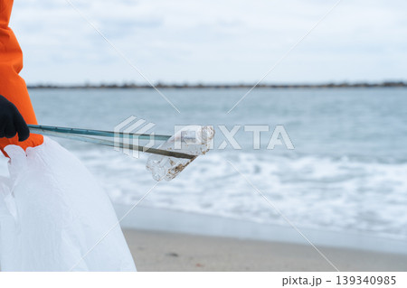 砂浜でゴミ拾いをする人 砂浜でゴミ拾いをする人 139340985