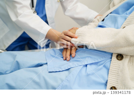 Asian doctor checking and treat elderly woman patient health in hospital. Asian doctor checking and treat elderly woman patient health in hospital. 139341178