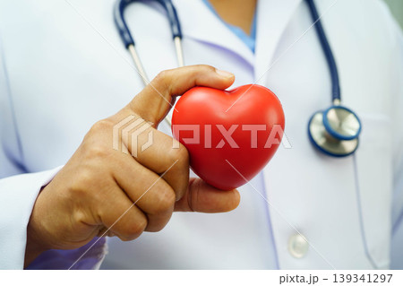 Asian woman doctor holding red heart for health in hospital. Asian woman doctor holding red heart for health in hospital. 139341297