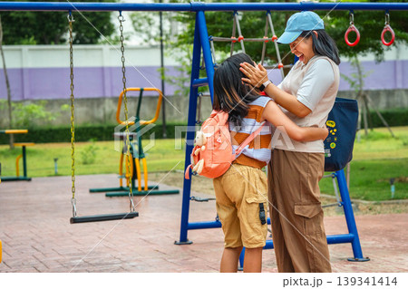 Happy Asian mother saying goodbye and sending her daughter to school, Back to school and family relationship concept. 139341414