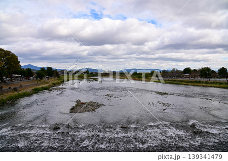 The view of Katsura River at autumn from Togetsukyo Bridge, Kyoto, Japan. A well-known place of scenic beauty in the western hills of Kyoto. Nature and travel concept. The view of Katsura River at autumn from Togetsukyo Bridge, Kyoto, Japan. A well-known place of scenic beauty in the western hills of Kyoto. Nature and travel concept. 139341479