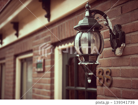 Street lamp hanging on a brick wall Street lamp hanging on a brick wall 139341739