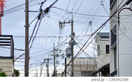 The view of utility pole, electric wires, electricity pylon at street in Kyoto, Japan. The view of utility pole, electric wires, electricity pylon at street in Kyoto, Japan. 139342586