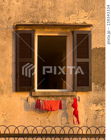 Underwear drying on a clothesline outside building window Underwear drying on a clothesline outside building window 139343334