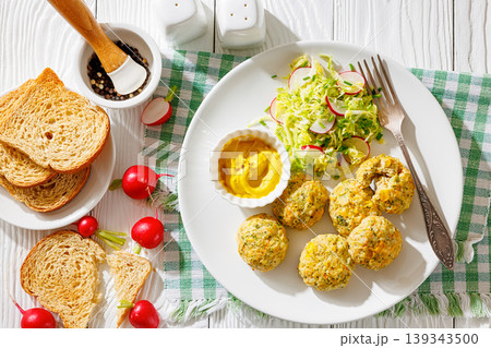 Baked meat and vegetable polpette with salad 139343500