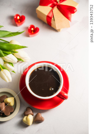 Valentine's day. Cup of coffee, heart chocolates, gift box and spring white tulip flower bouquet. Mother's day Valentine's day. Cup of coffee, heart chocolates, gift box and spring white tulip flower bouquet. Mother's day 139343752