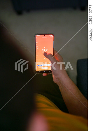 Smartphone connecting to heating system. Remote home control system on a smartphone. smart home 139343777