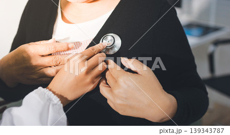 Pregnant woman having her belly examined by a doctor with a stethoscope in a clinic room highlighting a medical checkup, pregnancy health, and prenatal care Pregnant woman having her belly examined by a doctor with a stethoscope in a clinic room highlighting a medical checkup, pregnancy health, and prenatal care 139343787