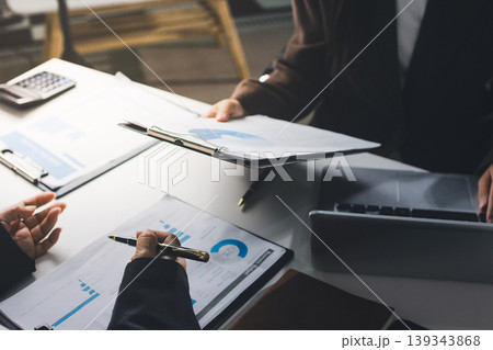 Accountants processing financial documents and taxes, managing corporate finance in a modern office. Audit and taxes in business Accountants processing financial documents and taxes, managing corporate finance in a modern office. Audit and taxes in business 139343868