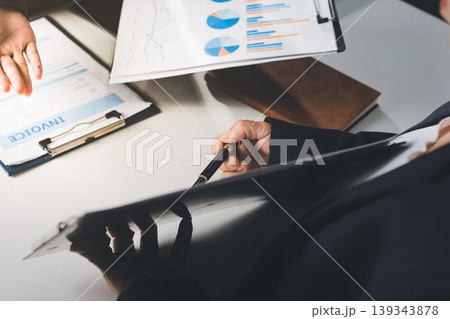 Accountants processing financial documents and taxes, managing corporate finance in a modern office. Audit and taxes in business Accountants processing financial documents and taxes, managing corporate finance in a modern office. Audit and taxes in business 139343878