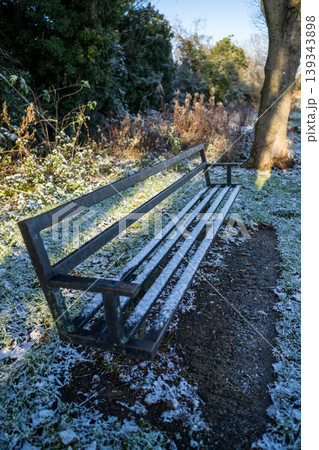 First snow, frozen bench in park, winter landscape First snow, frozen bench in park, winter landscape 139343898