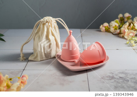 Menstrual cups. Pink feminine hygiene product. Women health concept. Menstrual cups. Pink feminine hygiene product. Women health concept. 139343946