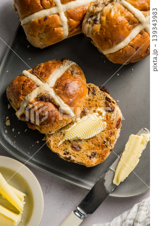 Cross Buns with butter in a plate. Breakfast concept. Top view. Easter treat buns Cross Buns with butter in a plate. Breakfast concept. Top view. Easter treat buns 139343983