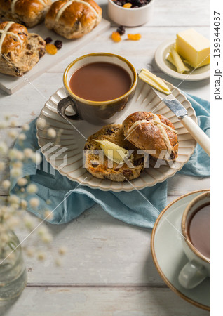 Easter food table setting. Cross Buns with butter, served with tea. Breakfast concept 139344037