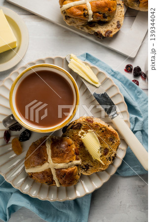 Cross Buns with butter in a plate. Breakfast concept. Top view. Easter treat buns 139344042