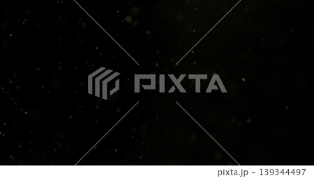 Close-up of floating dust particles in air, isolated on black background. Minimalist abstract texture with soft light, designed as VFX overlay for compositing. 139344497