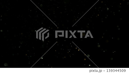 Close-up of floating dust particles in air, isolated on black background. Minimalist abstract texture with soft light, designed as VFX overlay for compositing. 139344509