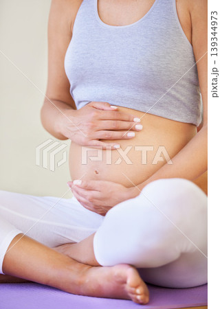 Pregnant woman, touch stomach and fitness in studio with relax wellness and exercise for prenatal care. Person, yoga mat and connection with fetus, lamaze class and maternity love with healthcare 139344973
