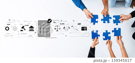 Collaborative Teamwork Concept with Hands Holding Blue Puzzle Pieces and Business Icons for Strategy and Problem Solving in Modern Workplace Trope 139345017