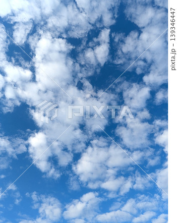 Moody white clouds across a blue black sky change in weather skyscape 139346447