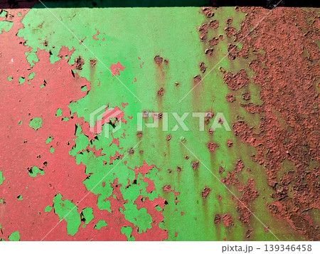 Close up of aged distressed chipped rusted paint work on a wall in green and red Close up of aged distressed chipped rusted paint work on a wall in green and red 139346458