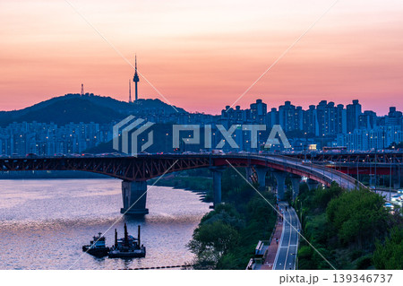 Seoul, South Korea - Apr. 24, 2026 : Sunset Cityscape of Seoul with N Seoul Tower, Seongsu Bridge and Busy Traffic on Gangbyeonbukro Highway Seoul, South Korea - Apr. 24, 2026 : Sunset Cityscape of Seoul with N Seoul Tower, Seongsu Bridge and Busy Traffic on Gangbyeonbukro Highway 139346737