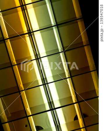 Directional LED lights on rails under the ceiling abstract lines in orange and white 139347018