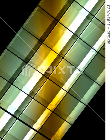 Directional LED lights on rails under the ceiling abstract lines in orange and white 139347023